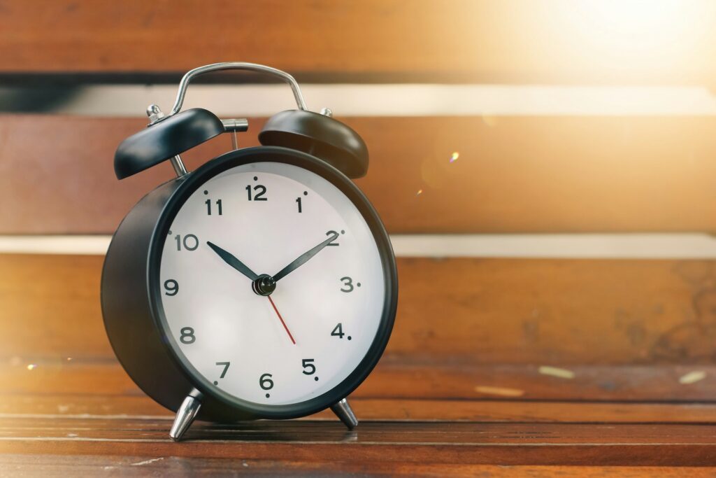 an alarm clock sitting on top of a wooden table