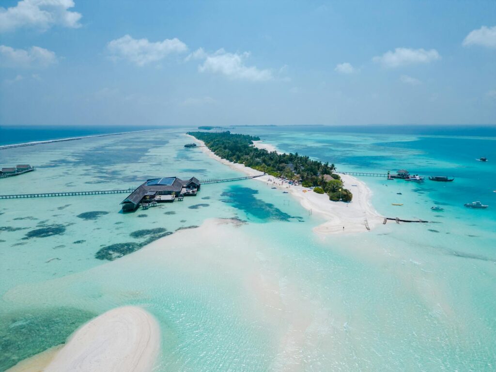 Stunning aerial view of Dhigurah Island's turquoise waters and sandy beaches in the Maldives.