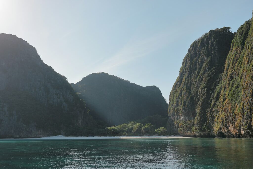 brown cliff beside body of water